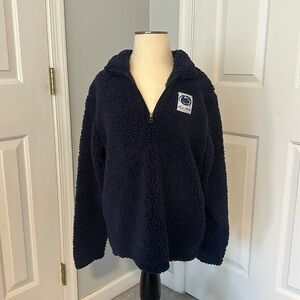 This is a Navy blue Penn State Sherpa quarter zip in a size Medium.